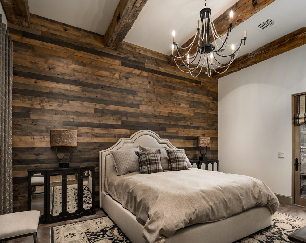 Photo of an expansive arts and crafts guest bedroom in Phoenix with multi-coloured walls, dark hardwood floors, a two-sided fireplace, a stone fireplace surround and brown floor.