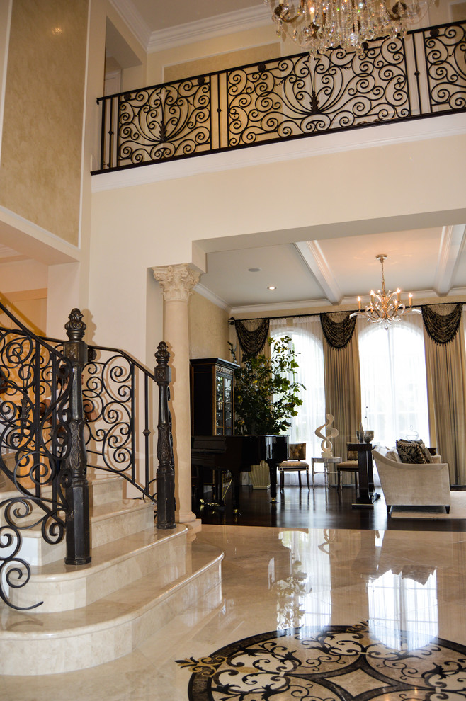 Large traditional foyer in Atlanta with beige walls, marble floors and beige floor.