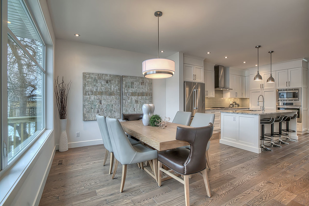 This is an example of a mid-sized transitional open plan dining in Calgary with grey walls, medium hardwood floors, no fireplace and brown floor.