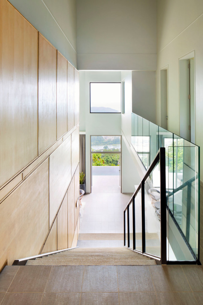 This is an example of a mid-sized modern concrete straight staircase in Other with concrete risers and metal railing.