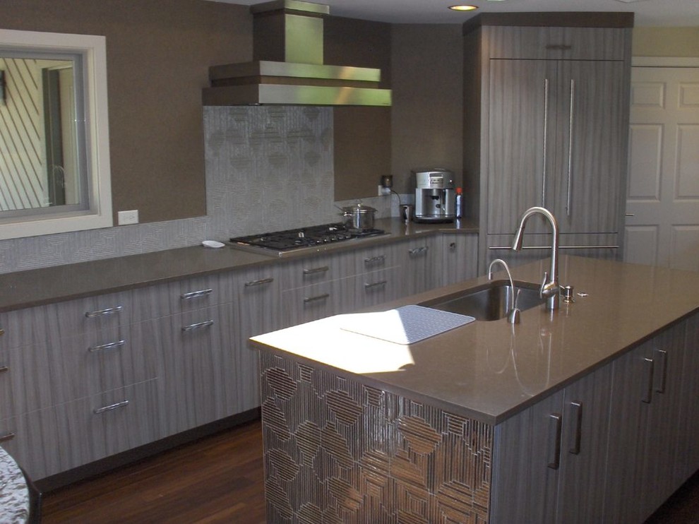 Eat-in kitchen - mid-sized transitional u-shaped medium tone wood floor and brown floor eat-in kitchen idea in Boise with a drop-in sink, flat-panel cabinets, gray cabinets, quartz countertops, gray backsplash, glass tile backsplash, stainless steel appliances and an island
