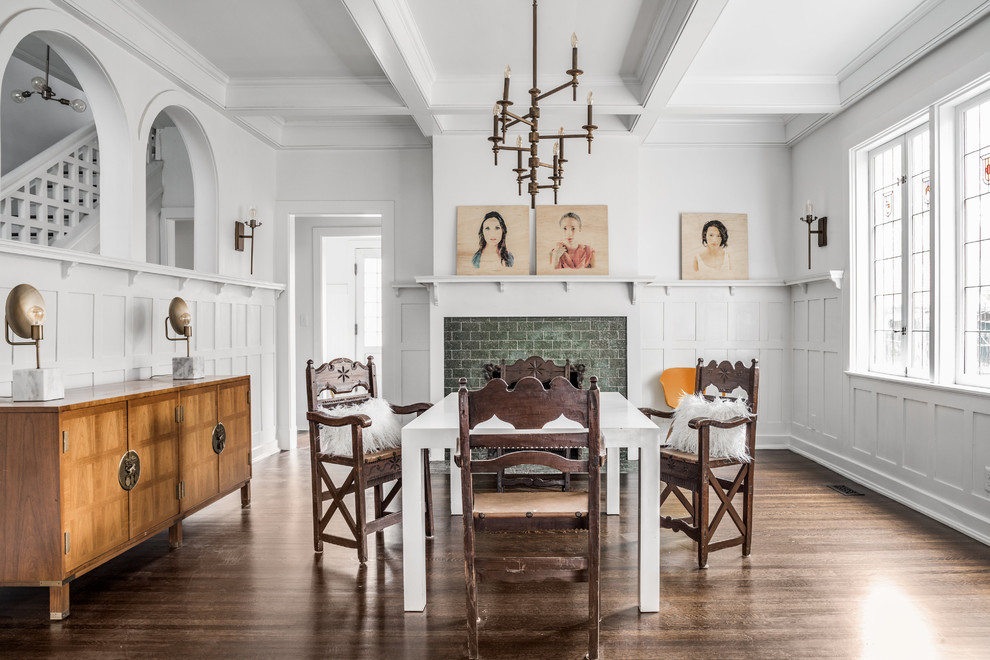 Traditional dining room in Indianapolis with white walls, dark hardwood floors, a standard fireplace and brown floor.
