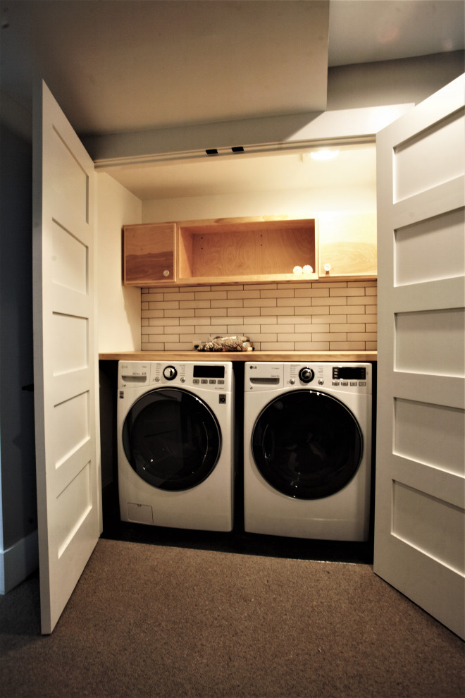 Inspiration for a small contemporary single-wall laundry cupboard in Seattle with open cabinets, light wood cabinets, wood benchtops, a side-by-side washer and dryer and beige benchtop.