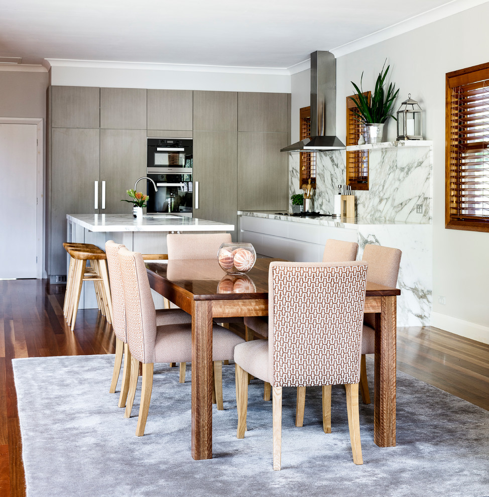 Large transitional open plan dining in Sydney with medium hardwood floors and multi-coloured floor.