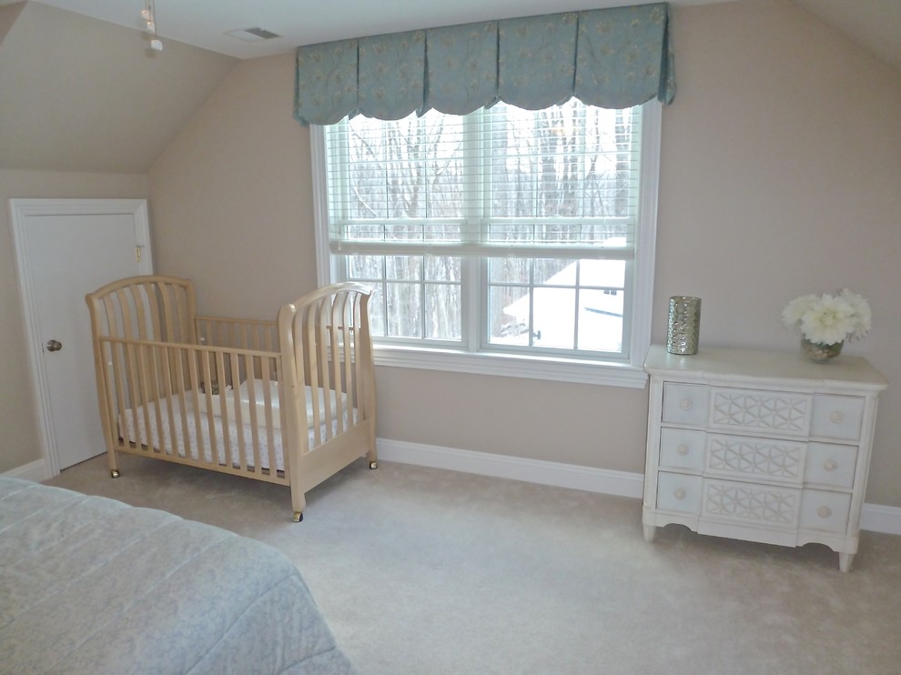 This is an example of a mid-sized traditional guest bedroom in New York with beige walls and carpet.