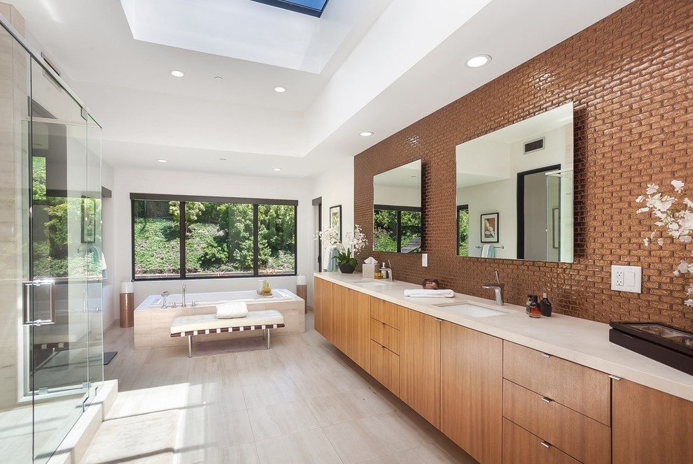 Design ideas for a contemporary master bathroom in San Francisco with flat-panel cabinets, medium wood cabinets, a drop-in tub, brown tile, glass tile, white walls, an undermount sink, grey floor and a hinged shower door.