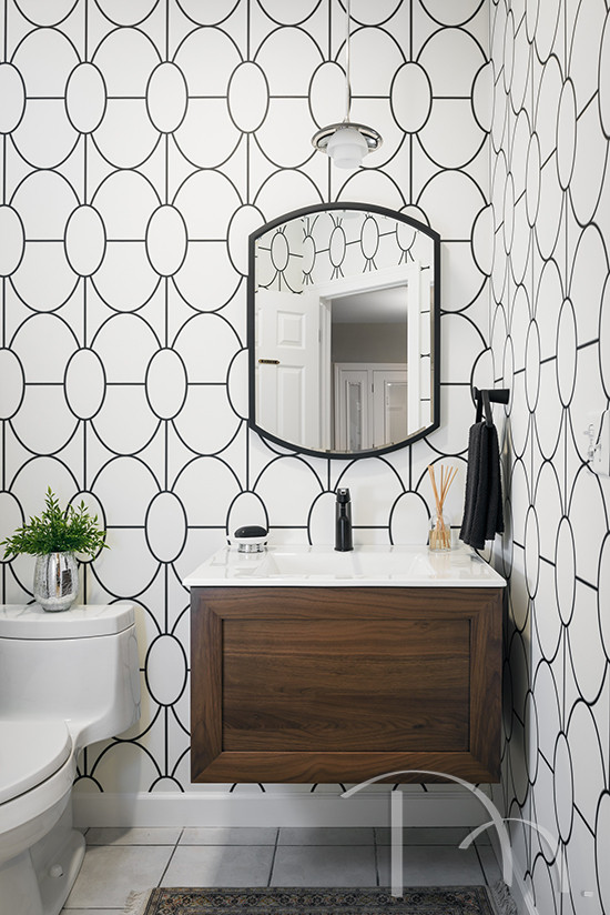 Powder room - small transitional porcelain tile, white floor and wallpaper powder room idea in St Louis with shaker cabinets, medium tone wood cabinets, quartz countertops, white countertops and a floating vanity