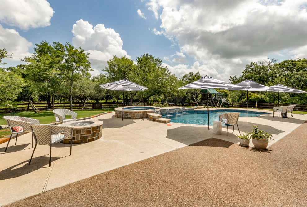 Example of a mid-sized backyard custom-shaped natural pool design with decking
