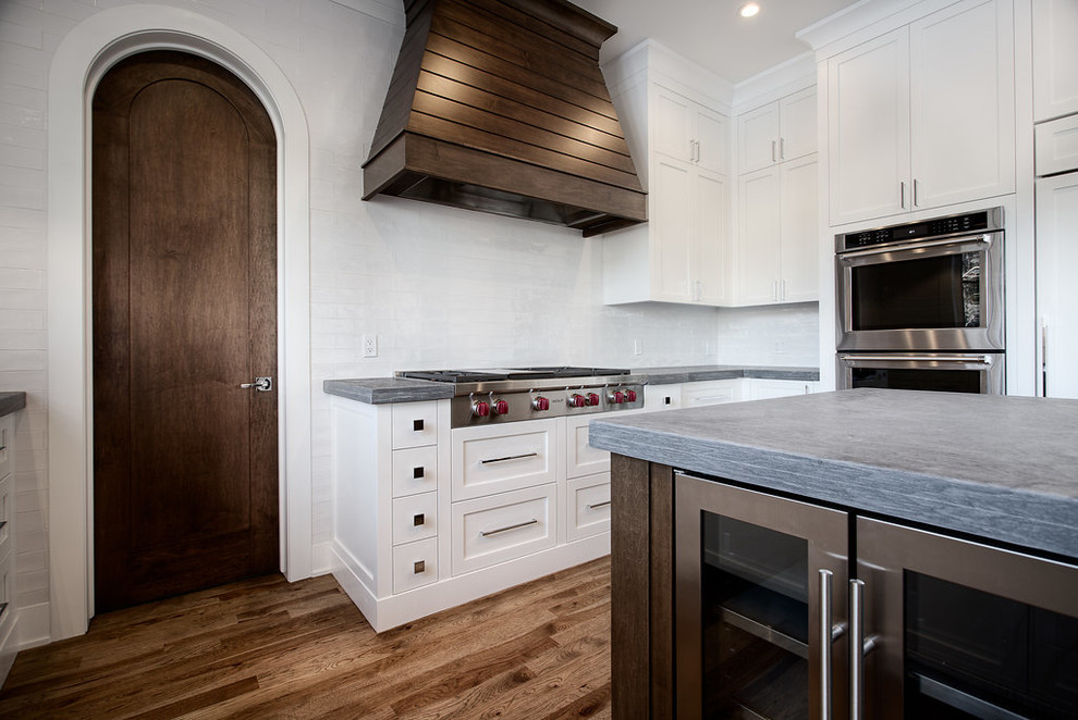 Eat-in kitchen - large transitional u-shaped eat-in kitchen idea in Calgary with shaker cabinets, paneled appliances and an island