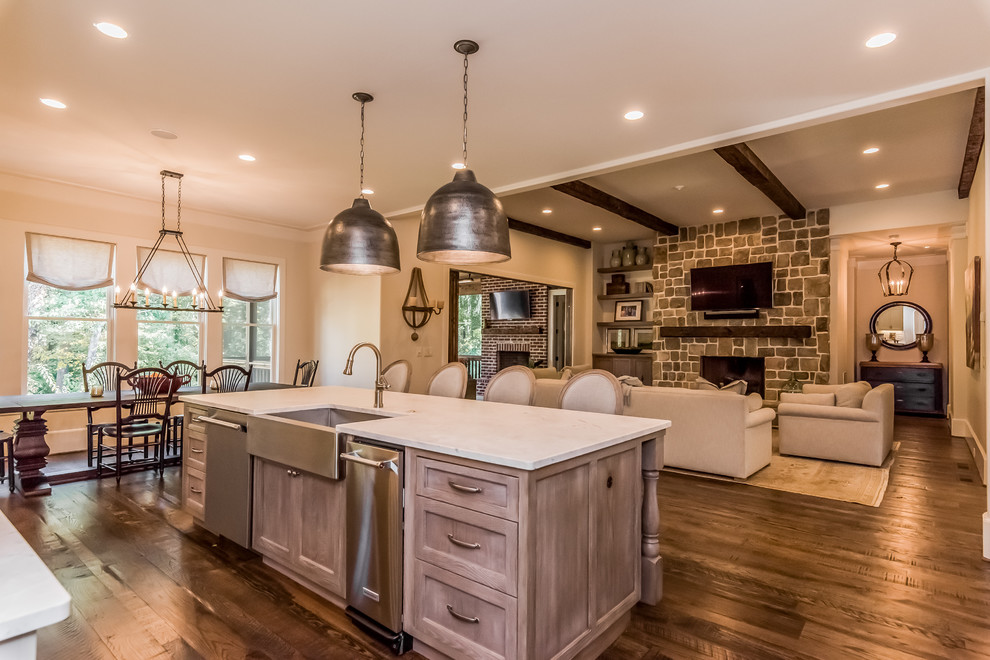 This is an example of a large transitional l-shaped open plan kitchen in Atlanta with a farmhouse sink, shaker cabinets, grey cabinets, marble benchtops, white splashback, stone tile splashback, stainless steel appliances, dark hardwood floors and with island.