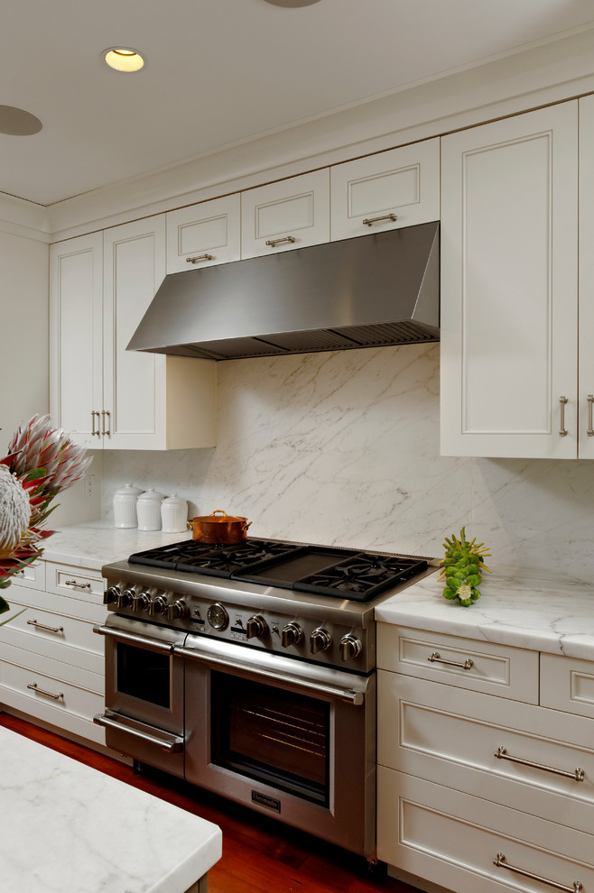 Inspiration for a mid-sized traditional l-shaped open plan kitchen in DC Metro with an undermount sink, white cabinets, wood benchtops, white splashback, stainless steel appliances, medium hardwood floors, with island, louvered cabinets and stone tile splashback.