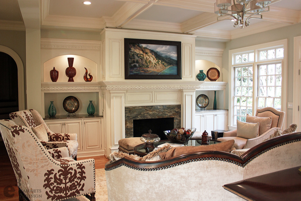 Inspiration for a mid-sized traditional formal enclosed living room in Charlotte with green walls, light hardwood floors, a standard fireplace and a stone fireplace surround.