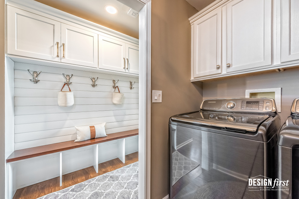 Mid-sized contemporary u-shaped dedicated laundry room in Chicago with shaker cabinets, white cabinets, wood benchtops, beige walls, ceramic floors, a side-by-side washer and dryer, grey floor, brown benchtop and planked wall panelling.