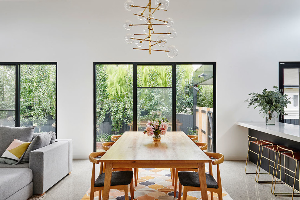 Photo of a modern open plan dining in Geelong with white walls, concrete floors and grey floor.