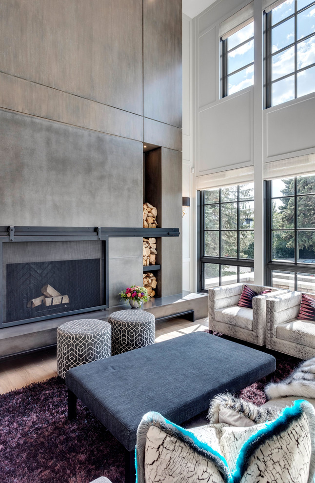 Photo of a large country formal open concept living room in Calgary with white walls, light hardwood floors, a standard fireplace, a concrete fireplace surround, no tv and beige floor.