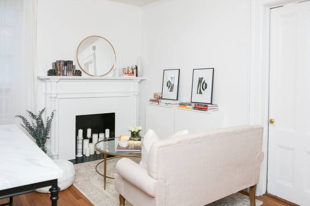 This is an example of a small transitional formal open concept living room in New York with white walls, dark hardwood floors, a standard fireplace, a plaster fireplace surround, no tv and brown floor.