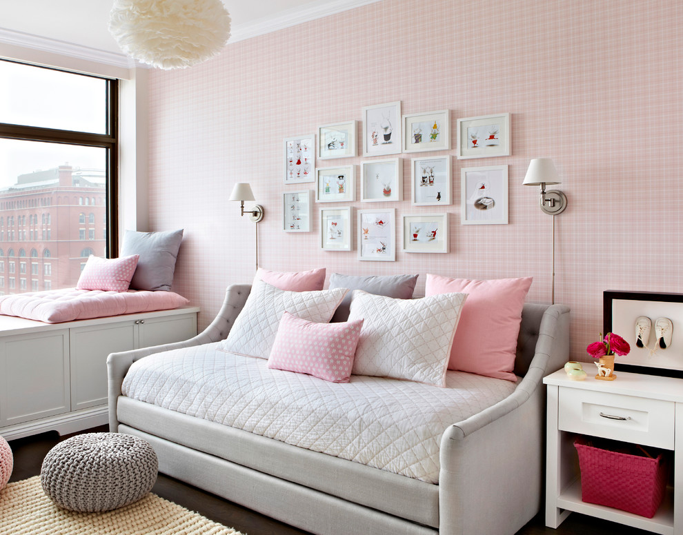 This is an example of a large transitional kids' bedroom for kids 4-10 years old and girls in New York with grey walls and dark hardwood floors.