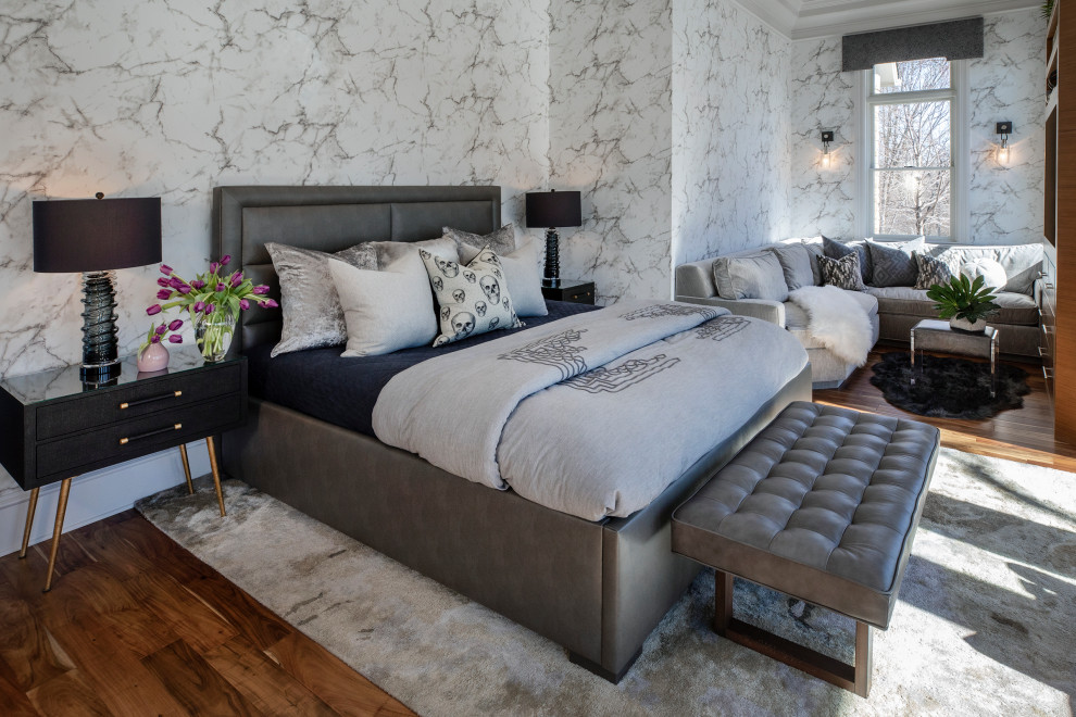 This is an example of an expansive transitional master bedroom in Minneapolis with medium hardwood floors and wallpaper.