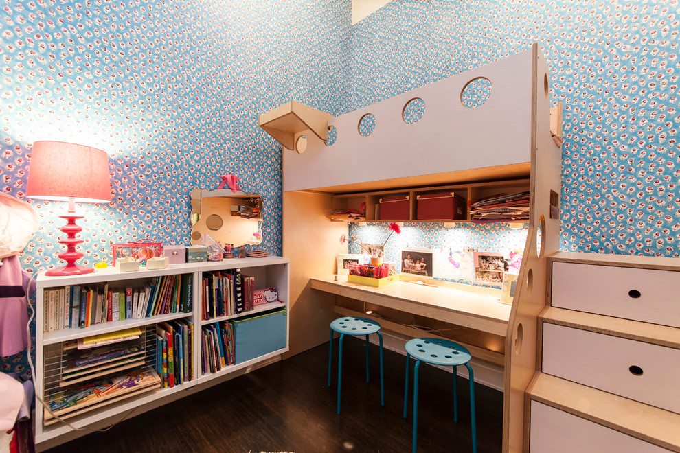 Design ideas for a small contemporary kids' bedroom for kids 4-10 years old and girls in New York with blue walls and dark hardwood floors.