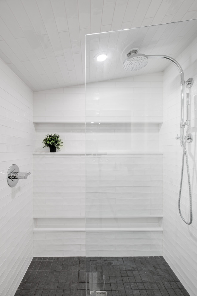 This is an example of a small midcentury ensuite bathroom in Other with a built-in shower, a wall mounted toilet, white tiles, ceramic tiles, white walls, wood-effect flooring, a wall-mounted sink, grey floors, an open shower, a wall niche and a single sink.