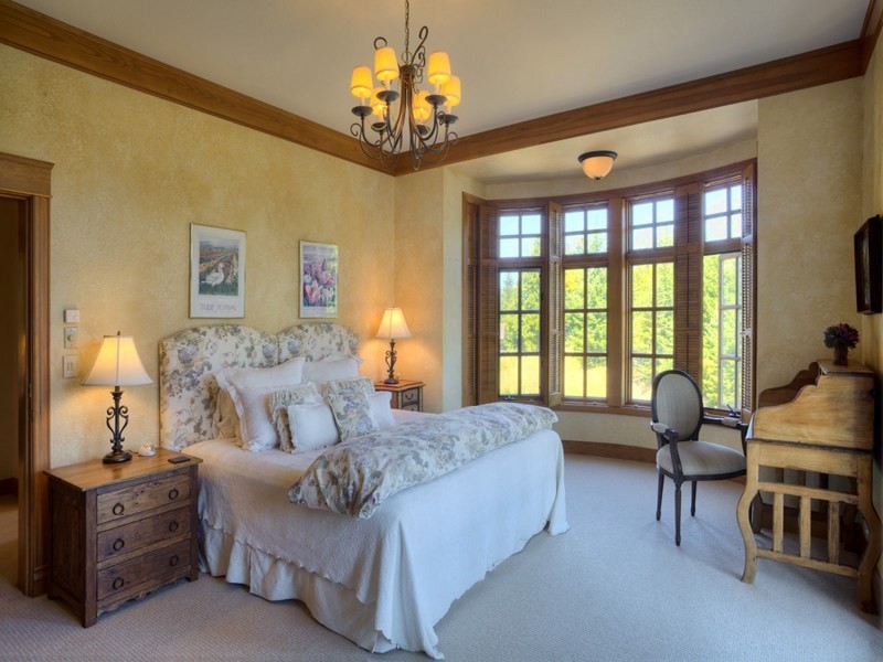 Mid-sized country guest bedroom in Seattle with beige walls, carpet and no fireplace.