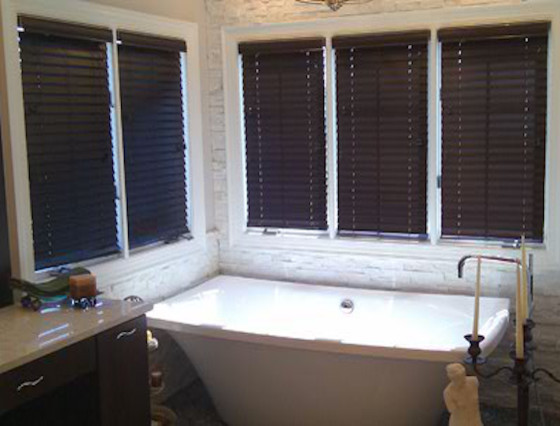Inspiration for a master freestanding bathtub remodel in Other with dark wood cabinets