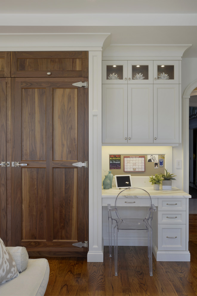 Inspiration for a large transitional l-shaped medium tone wood floor and brown floor open concept kitchen remodel in New York with an undermount sink, shaker cabinets, white cabinets, marble countertops, white backsplash, marble backsplash, paneled appliances and an island