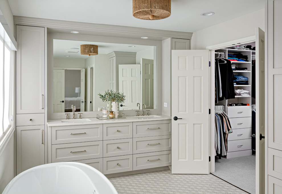 Inspiration for a medium sized classic ensuite bathroom in Minneapolis with flat-panel cabinets, grey cabinets, a freestanding bath, an alcove shower, a one-piece toilet, grey walls, porcelain flooring, a submerged sink, quartz worktops, grey floors, a hinged door, white worktops, double sinks and a built in vanity unit.