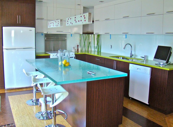 This is an example of a mid-sized eclectic l-shaped kitchen in Austin with a double-bowl sink, flat-panel cabinets, dark wood cabinets, glass benchtops, blue splashback, glass sheet splashback, white appliances, dark hardwood floors, with island, brown floor and blue benchtop.