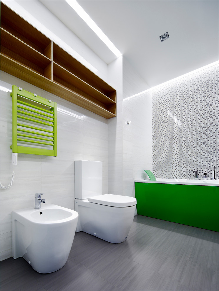 Mid-sized contemporary kids bathroom in Other with a bidet, white tile, ceramic floors, flat-panel cabinets, orange cabinets, an alcove tub, ceramic tile, brown walls, a trough sink and glass benchtops.
