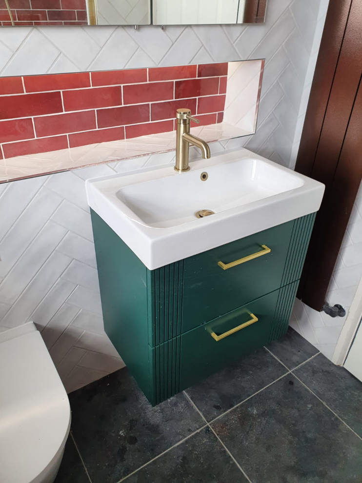 Mid-sized trendy master white tile and porcelain tile porcelain tile, black floor and single-sink bathroom photo in Dublin with furniture-like cabinets, green cabinets, a wall-mount toilet, red walls, a drop-in sink and a floating vanity