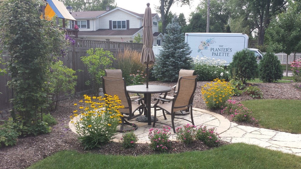 Photo of a small country garden in Chicago with natural stone pavers.