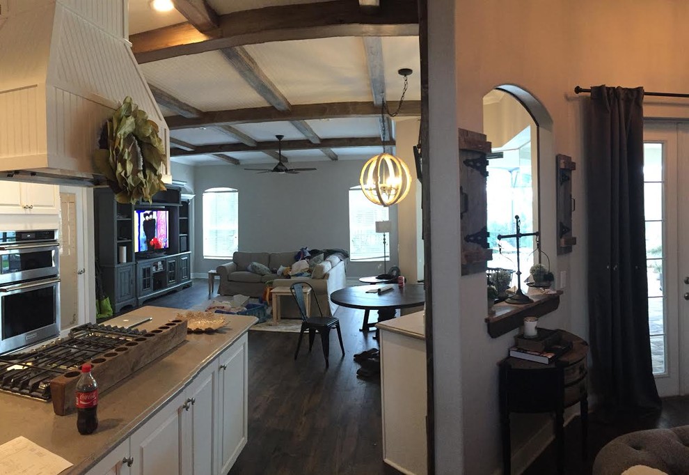 Example of a large transitional l-shaped dark wood floor and brown floor enclosed kitchen design in Tampa with raised-panel cabinets, white cabinets, stainless steel appliances and an island