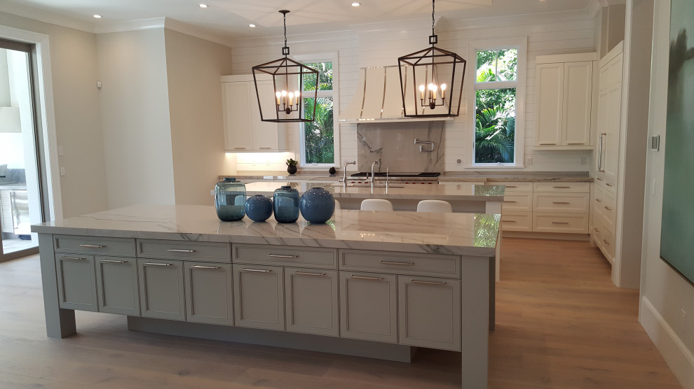 Expansive beach style galley eat-in kitchen in Other with an undermount sink, flat-panel cabinets, grey cabinets, quartzite benchtops, white splashback, shiplap splashback, white appliances, laminate floors, with island, brown floor, beige benchtop and recessed.