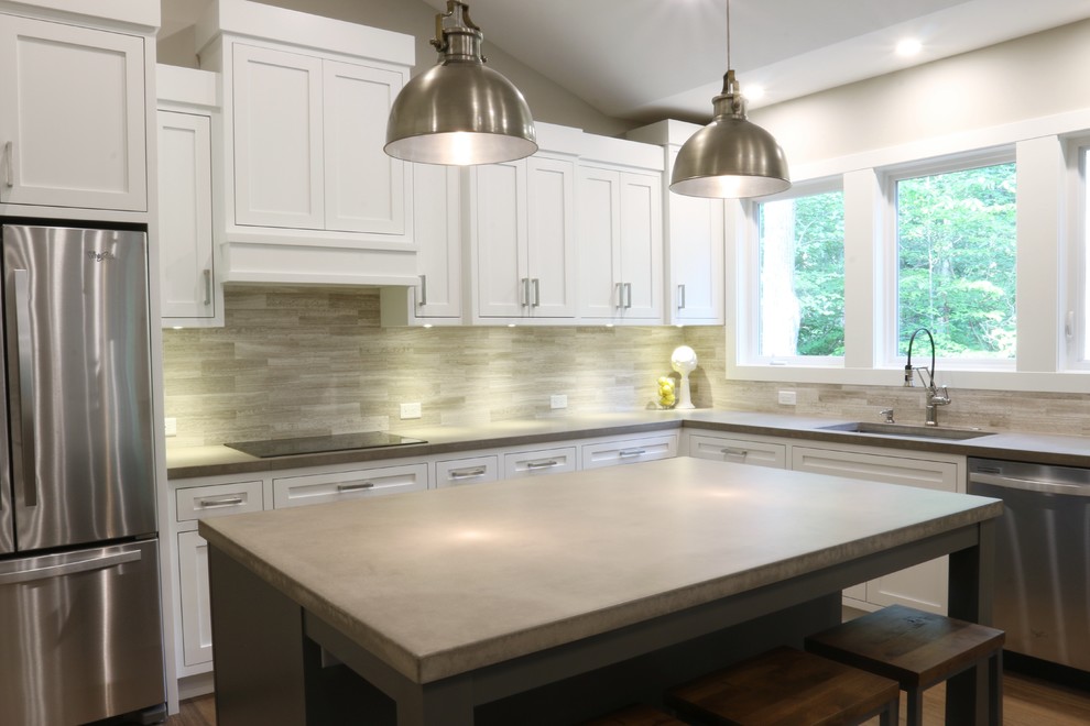Open concept kitchen - large transitional l-shaped dark wood floor open concept kitchen idea in Grand Rapids with an undermount sink, shaker cabinets, white cabinets, quartz countertops, beige backsplash, porcelain backsplash, stainless steel appliances and an island