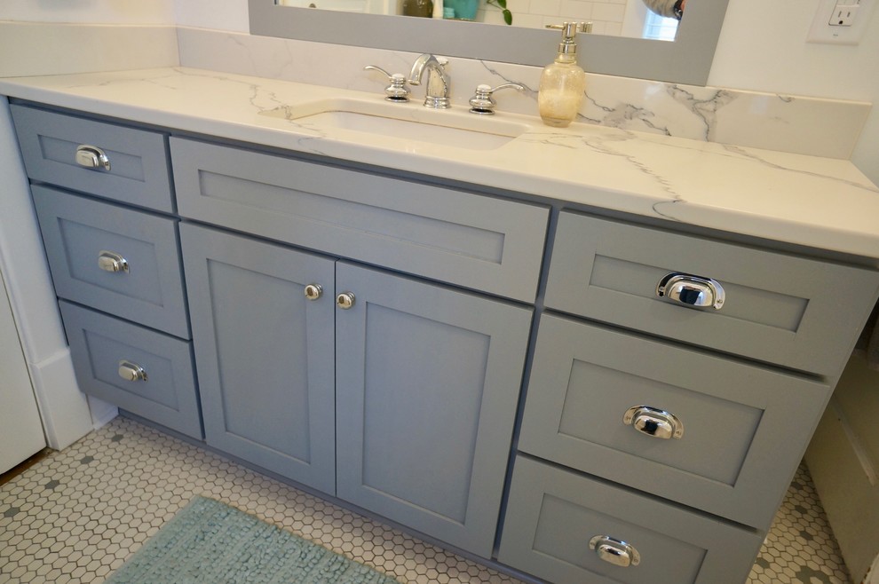 This is an example of a small traditional master bathroom in Minneapolis with shaker cabinets, grey cabinets, a two-piece toilet, white tile, subway tile, white walls, mosaic tile floors, an undermount sink, engineered quartz benchtops, a shower curtain, an alcove tub, a shower/bathtub combo, white floor, white benchtops, a single vanity and a freestanding vanity.