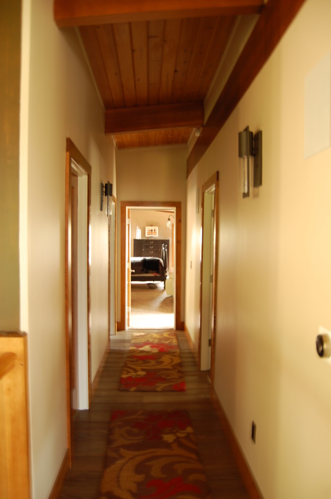 Design ideas for a mid-sized midcentury hallway in Portland with beige walls and dark hardwood floors.