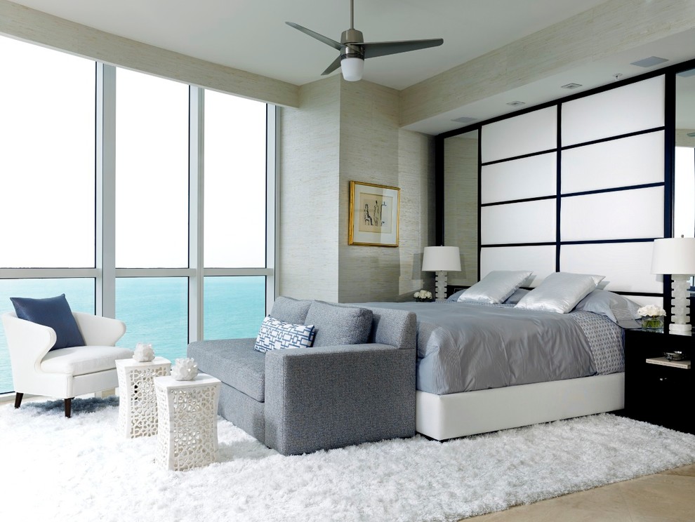 Large modern master bedroom in Miami with beige walls, marble floors and no fireplace.