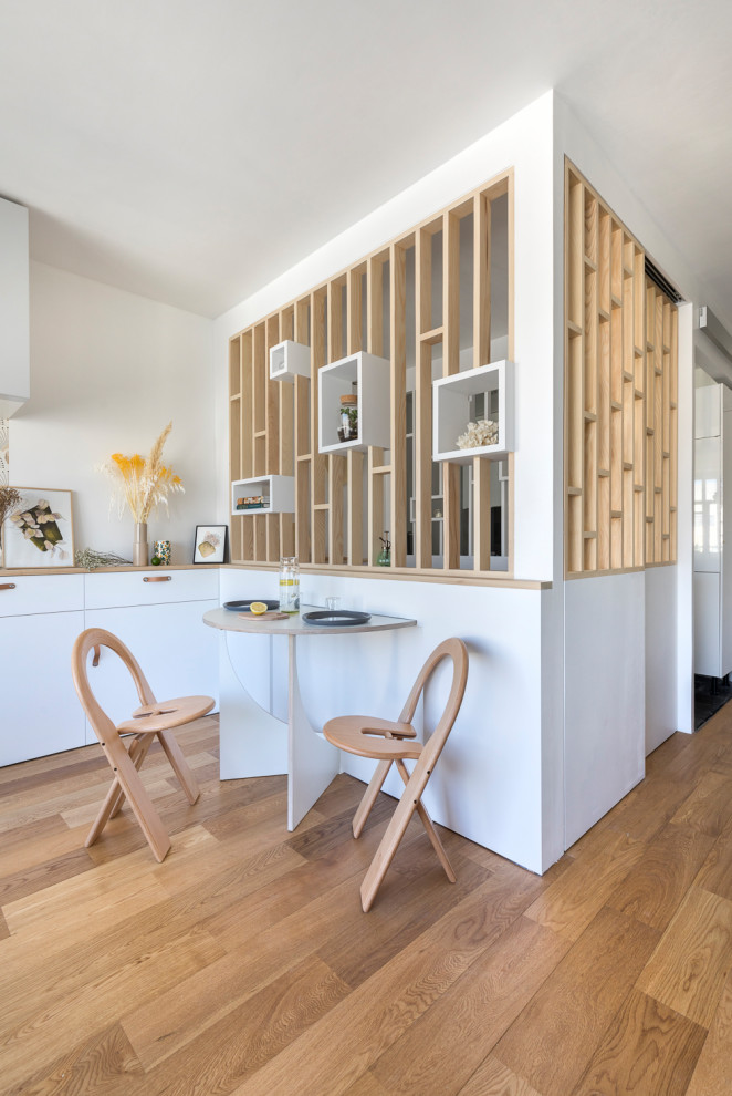 Inspiration for a contemporary open plan dining in Paris with plywood floors.
