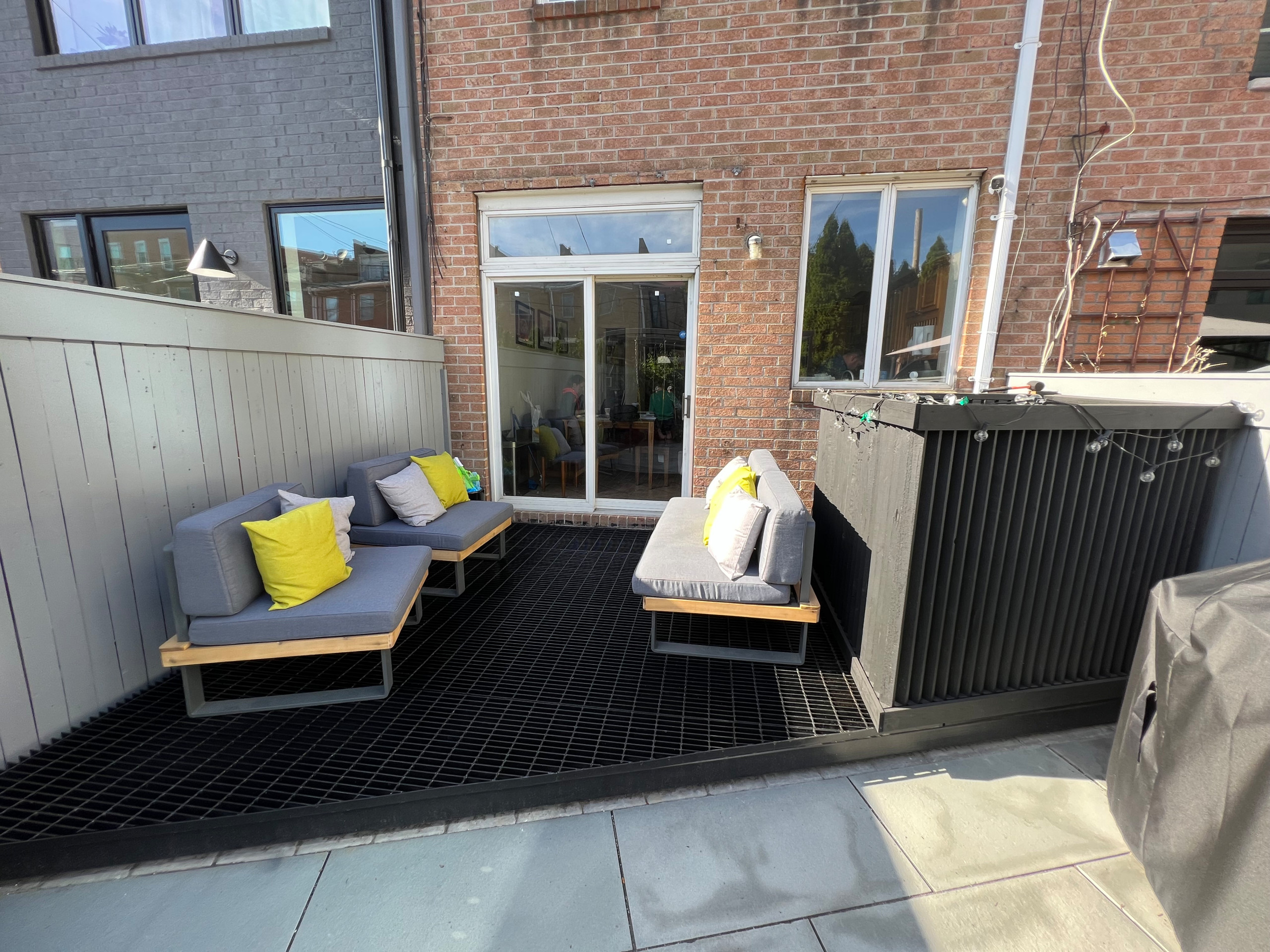 Paved patio with metal grating garden