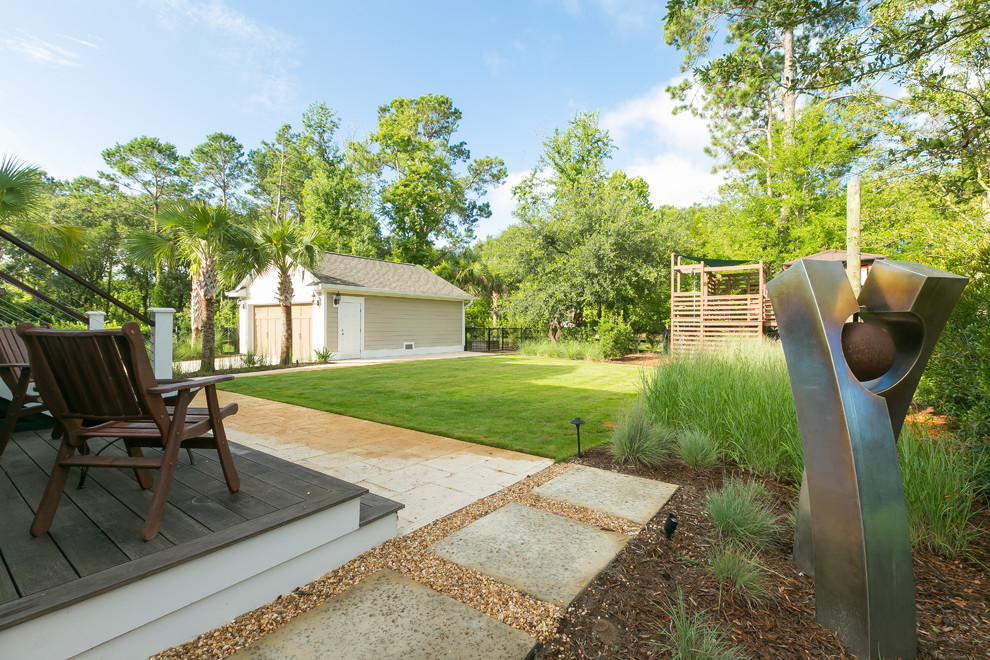 Inspiration for a contemporary backyard driveway in Charleston with with outdoor playset and concrete pavers.