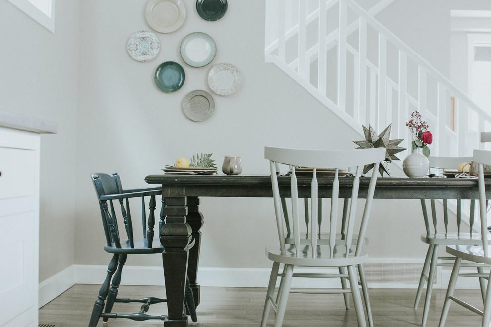 Inspiration for a transitional medium tone wood floor eat-in kitchen remodel in Calgary with an undermount sink, shaker cabinets, white cabinets, quartzite countertops, mosaic tile backsplash and stainless steel appliances