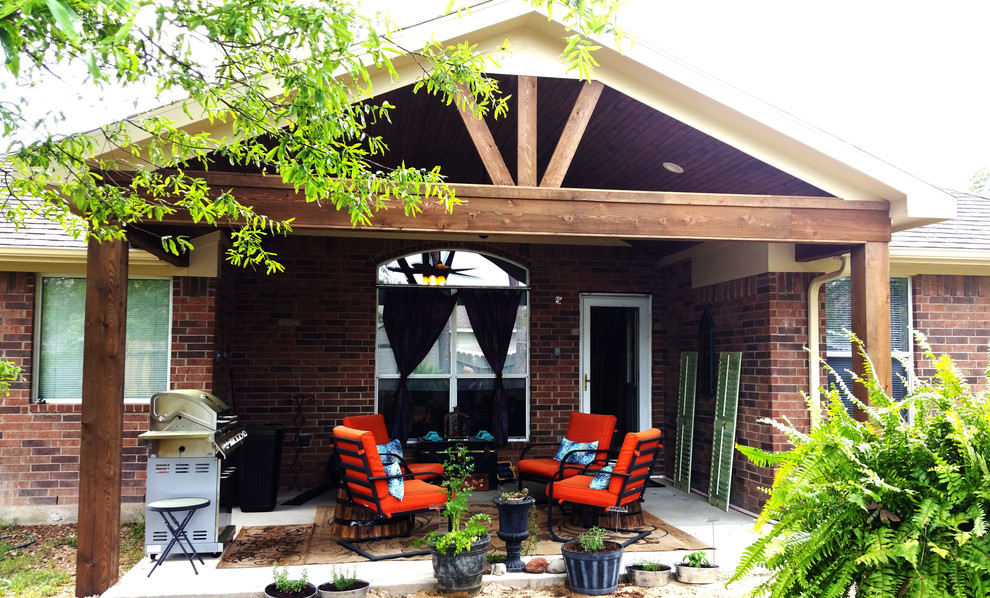 Example of a mid-sized farmhouse backyard patio kitchen design in Houston with a roof extension