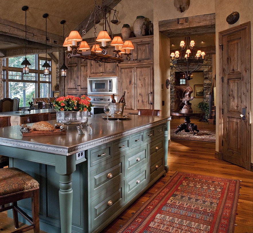Inspiration for a large traditional eat-in kitchen in Minneapolis with raised-panel cabinets, medium wood cabinets, soapstone benchtops, panelled appliances, light hardwood floors and a peninsula.