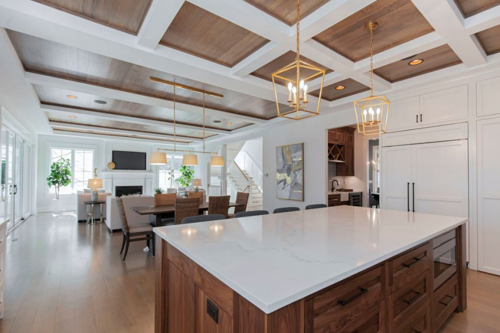 Design ideas for a large country u-shaped kitchen in Chicago with an undermount sink, shaker cabinets, white cabinets, quartz benchtops, grey splashback, subway tile splashback, stainless steel appliances, light hardwood floors, with island, brown floor, white benchtop and coffered.