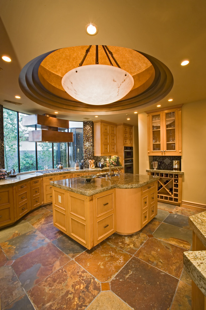 This is an example of a mediterranean kitchen in Las Vegas with light wood cabinets.