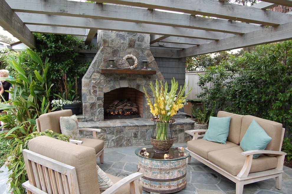 Design ideas for a beach style patio in Orange County with a fire feature and a pergola.