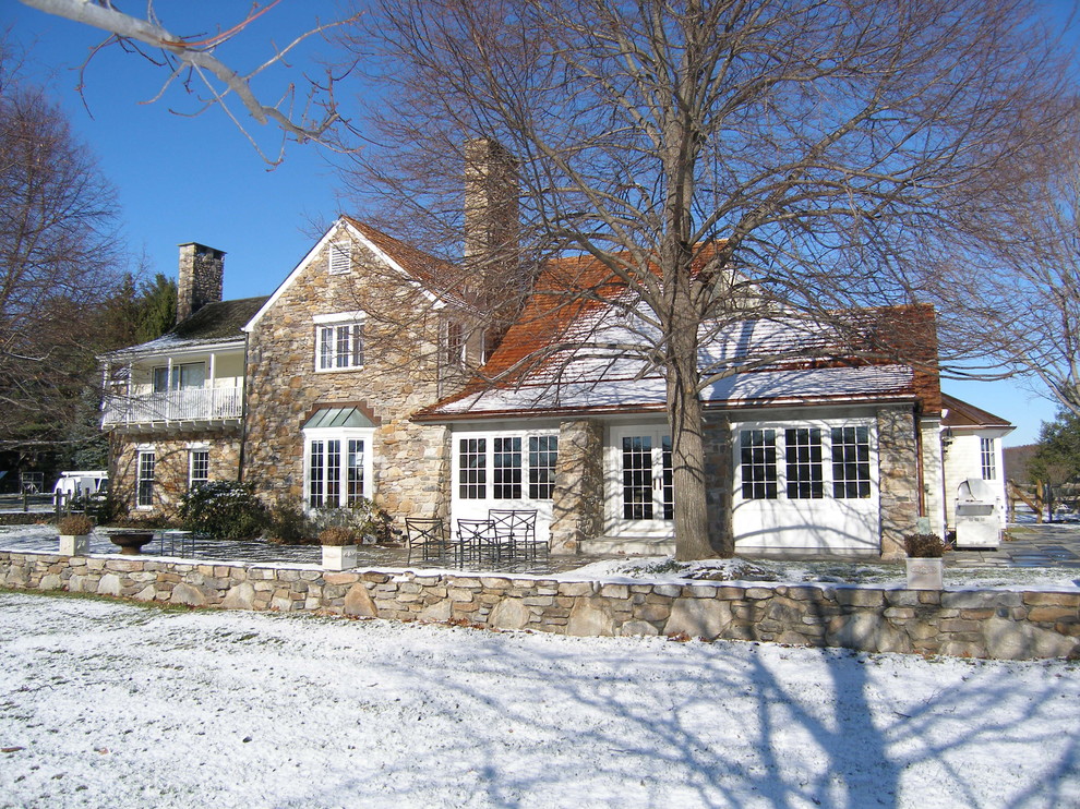 Traditional two-storey exterior in Philadelphia with stone veneer and a gable roof.