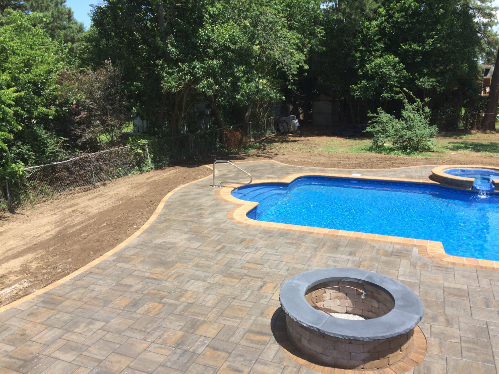 Hot tub - large transitional backyard concrete paver and custom-shaped hot tub idea