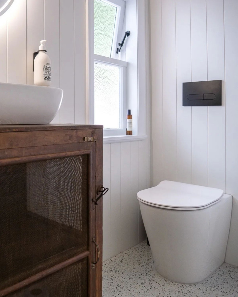This is an example of a small scandinavian master bathroom in Perth with furniture-like cabinets, dark wood cabinets, an open shower, a one-piece toilet, white tile, porcelain tile, porcelain floors, a vessel sink, wood benchtops, an open shower, brown benchtops, a niche, a single vanity, a freestanding vanity, exposed beam and planked wall panelling.